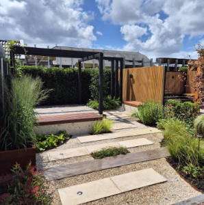 Tuin met grind en staptegels. Veel groen